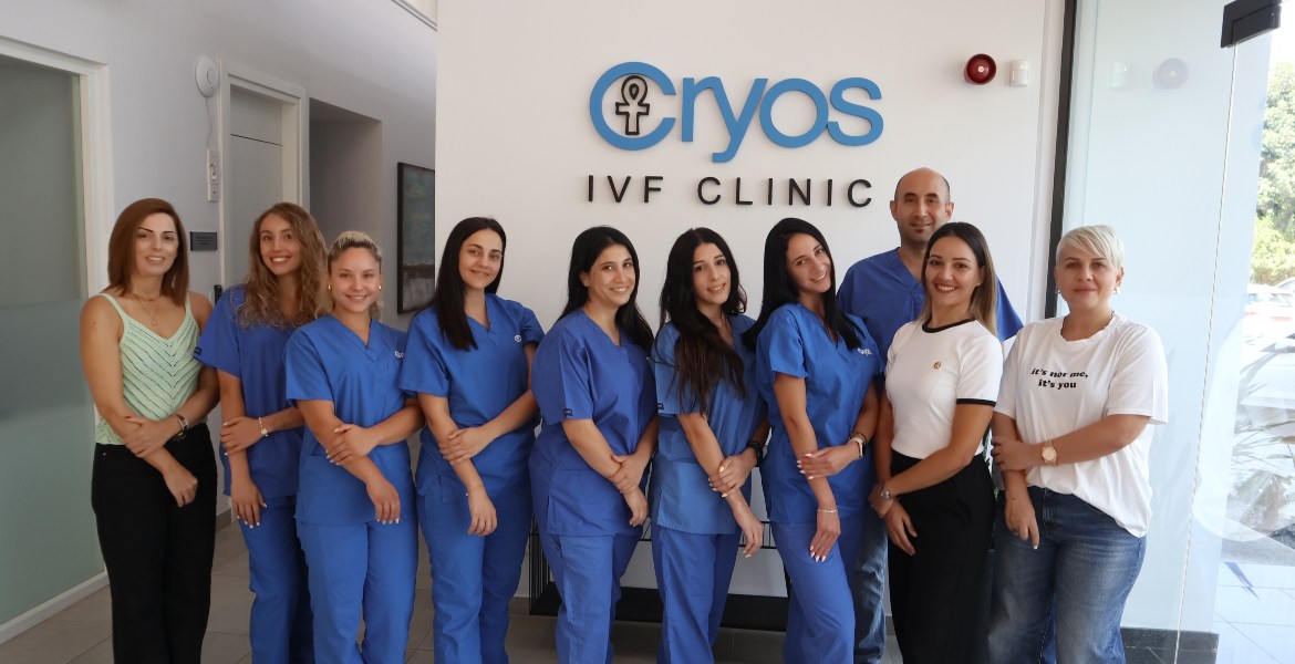 Group photo of Cryos International IVF Clinic staff in Cyprus, including nurses and administrative team, standing and smiling in the clinic reception area